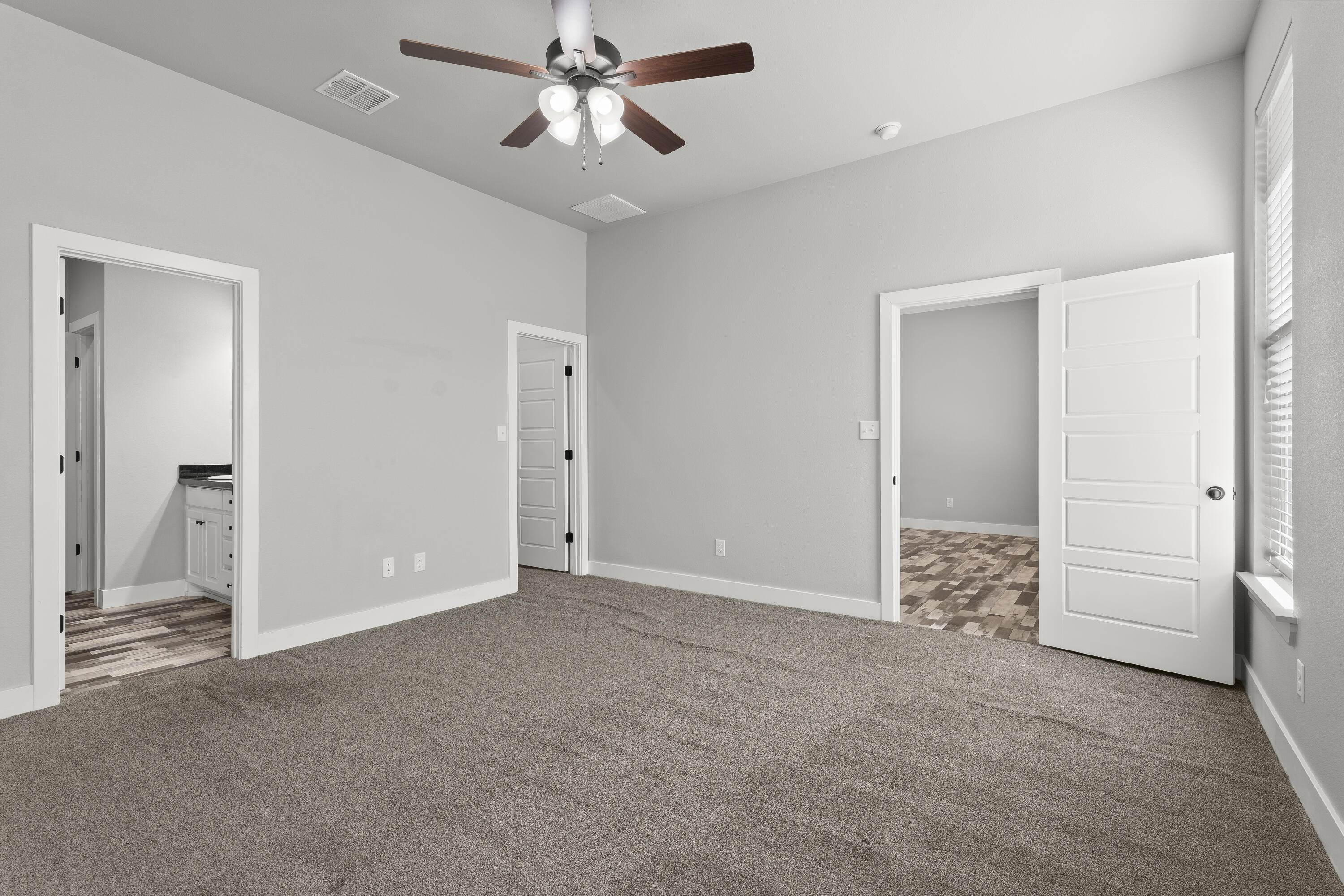 7605 58th Street Lubbock, TX 79407 - Photo 9 of 19 an empty room with closet and a chandelier fan