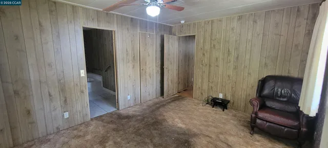 a view of a hallway with couch and closet