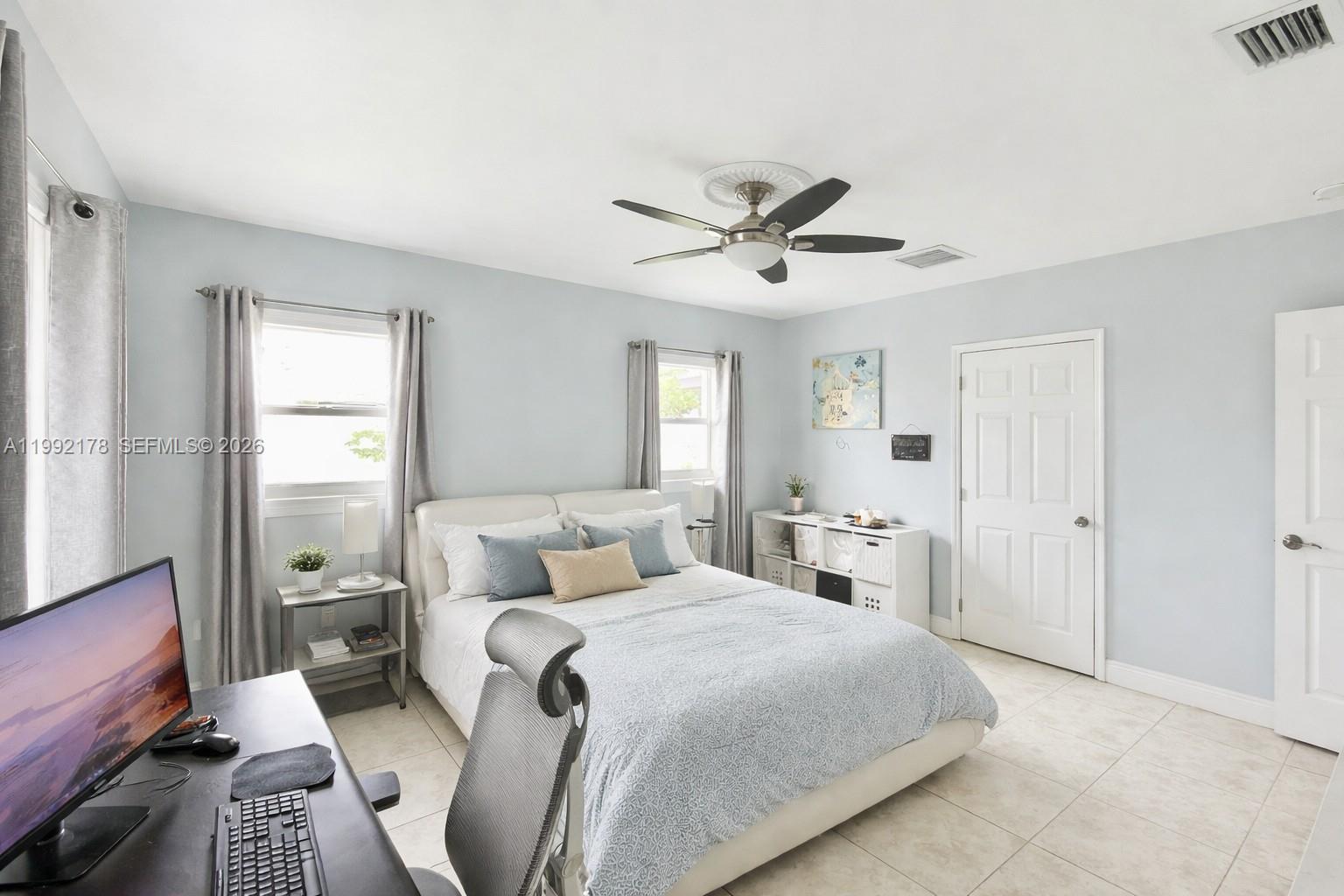 5820 Southwest 113th Court Miami, FL 33173 - Photo 11 of 22 a bedroom with a large bed and a window