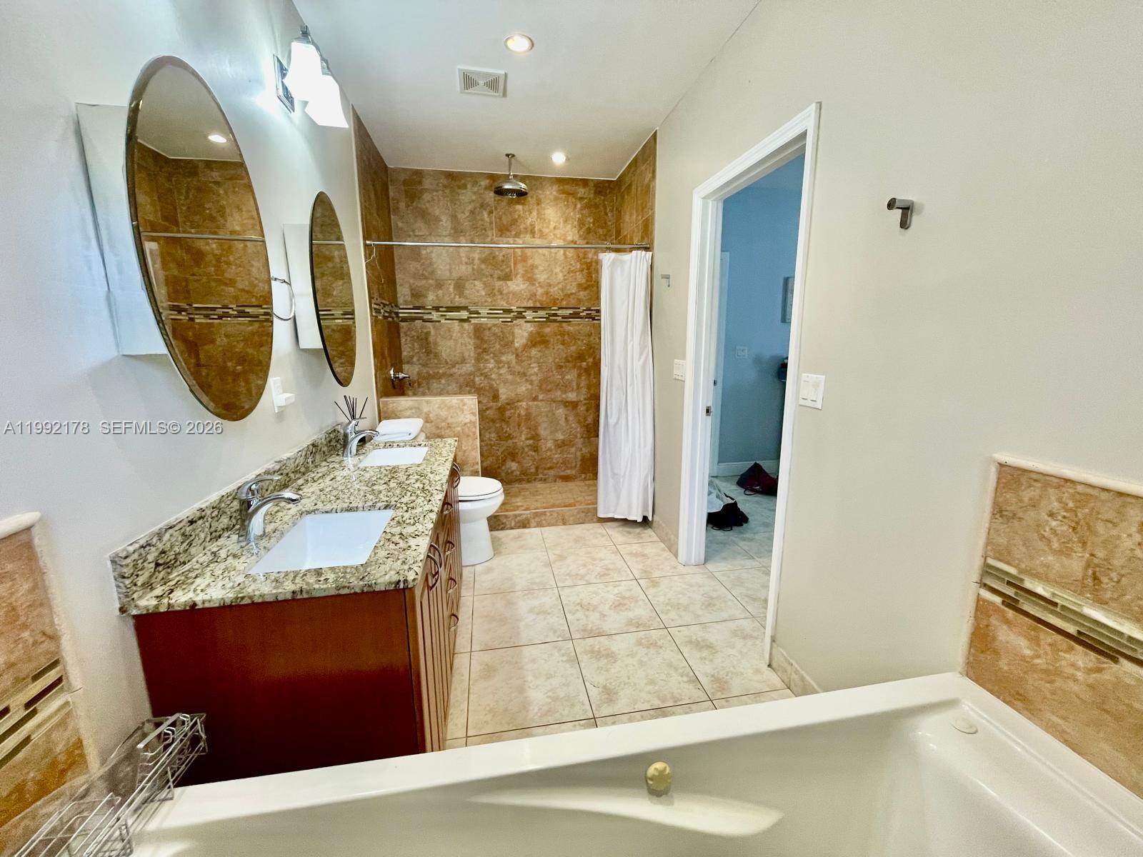 5820 Southwest 113th Court Miami, FL 33173 - Photo 12 of 22 a bathroom with a sink and a mirror