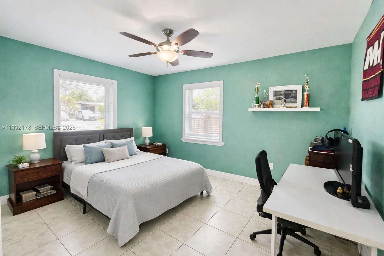 5820 Southwest 113th Court Miami, FL 33173 - Photo 14 of 22 a bedroom with a bed and a table in it