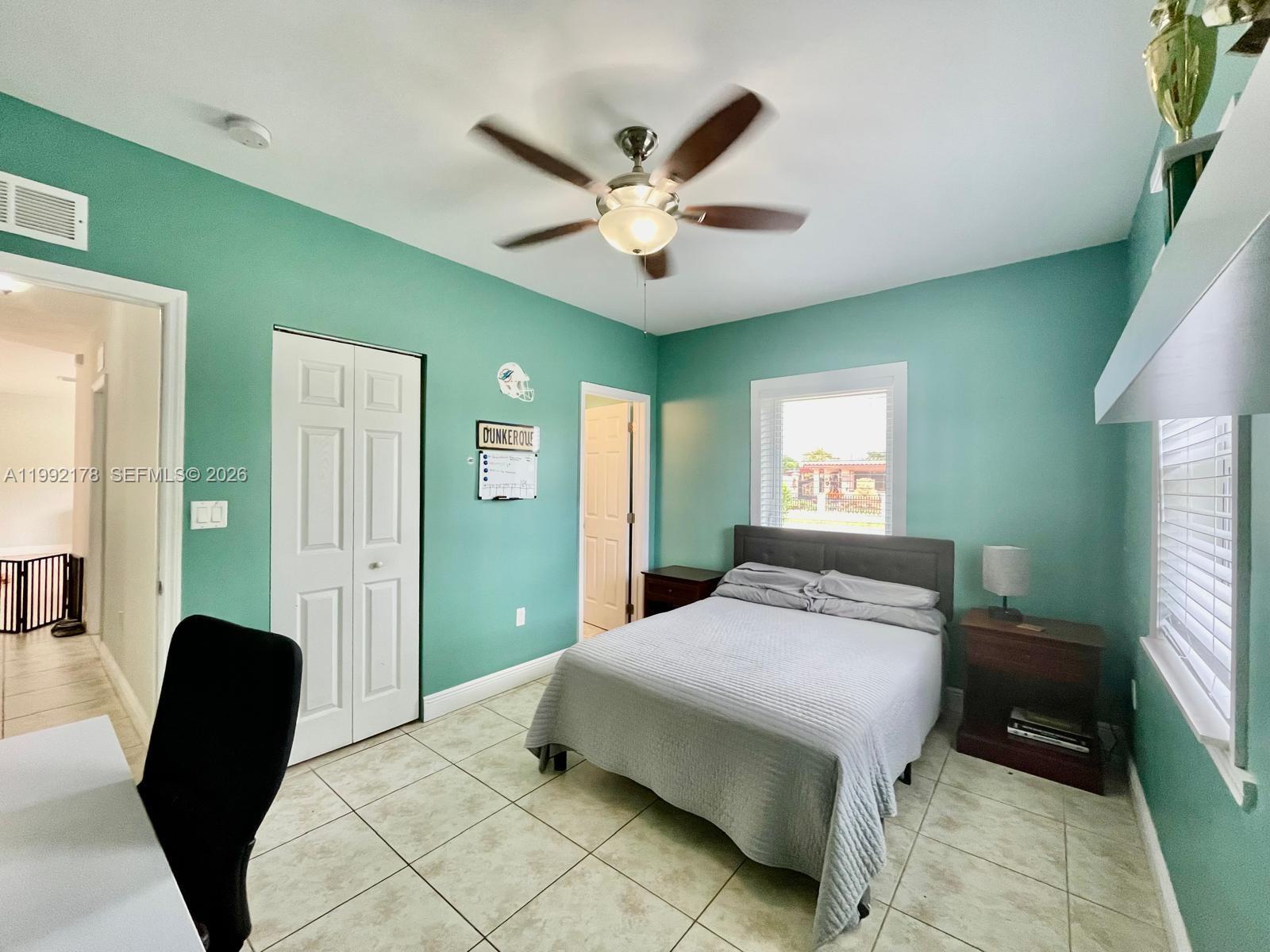 5820 Southwest 113th Court Miami, FL 33173 - Photo 16 of 22 a bedroom with a bed and a chandelier