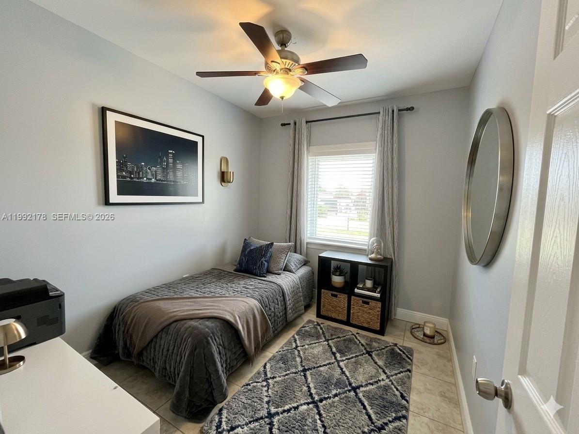 5820 Southwest 113th Court Miami, FL 33173 - Photo 18 of 22 a bedroom with a bed and a chandelier