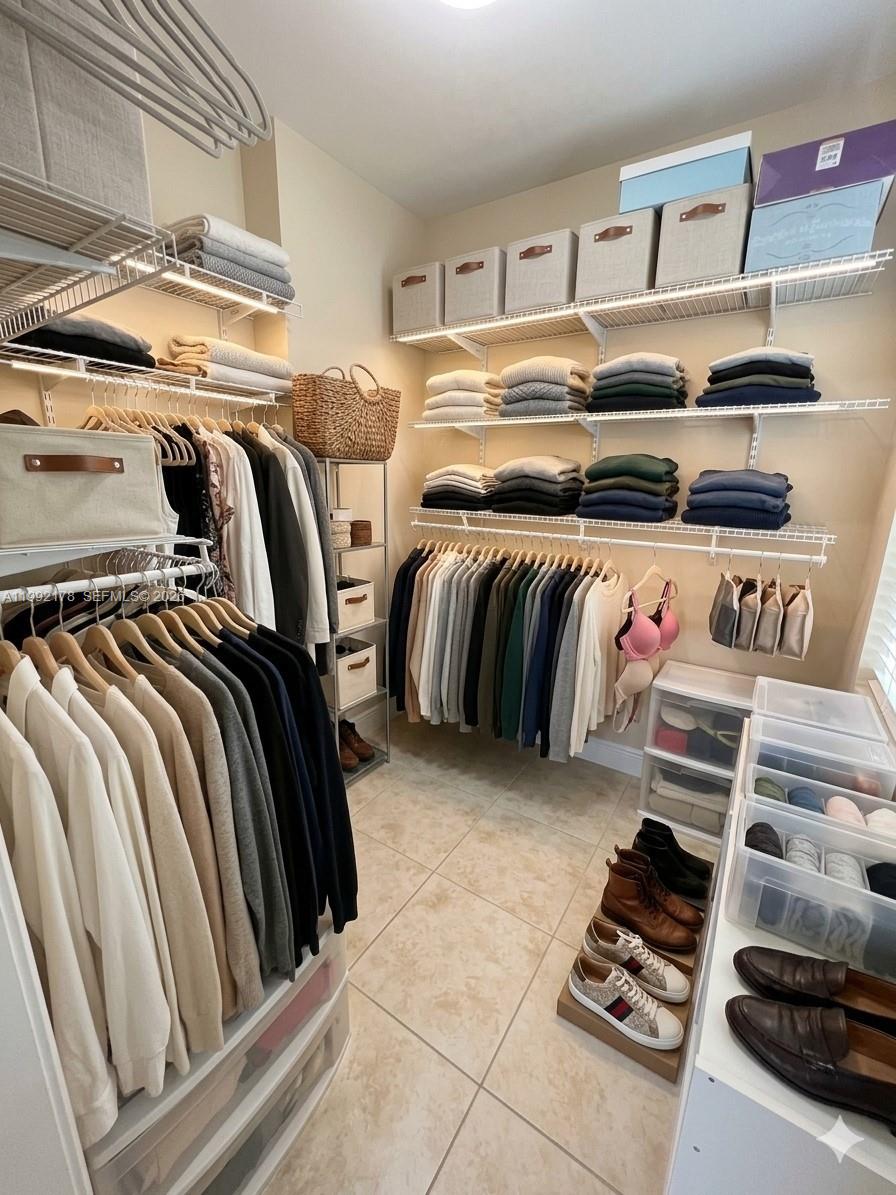 5820 Southwest 113th Court Miami, FL 33173 - Photo 10 of 22 a view of walk in closet with clothes and shoes