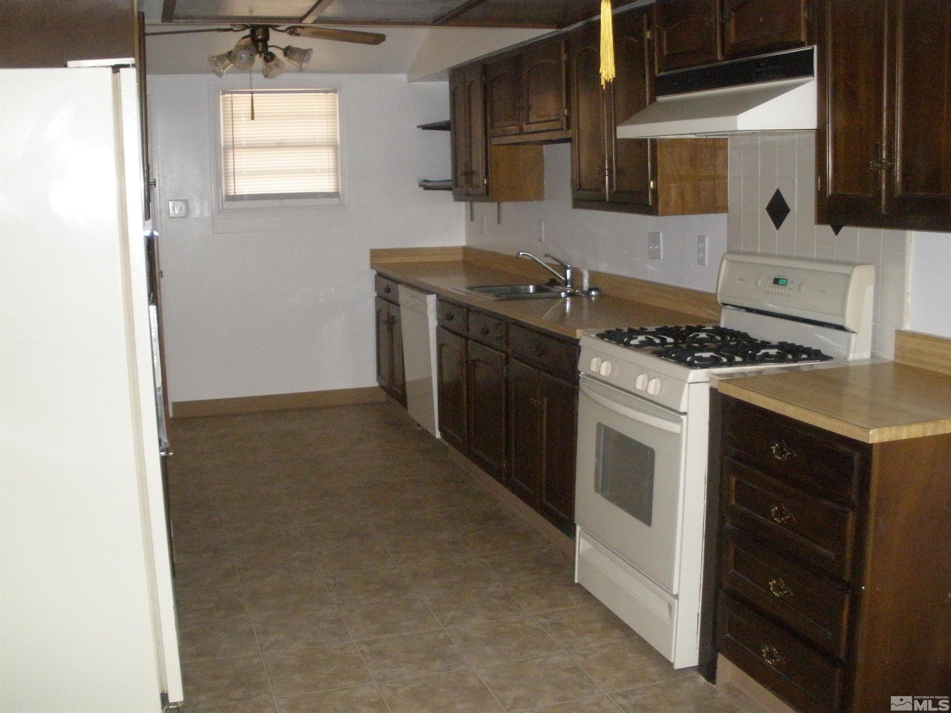 45 Sutton Way Reno, NV 89512 - Photo 3 of 20 a kitchen with a stove and a sink