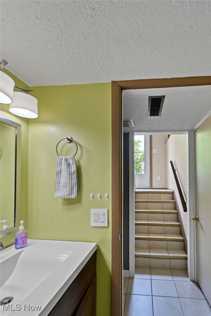 2610 Norton Road Stow, OH 44224 - Photo 27 of 41 Lower level. Bathroom with vanity, tile patterned floors, and a textured ceiling