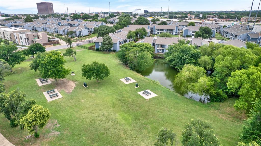 9471 Timberleaf Drive Dallas, TX 75243 - Photo 37 of 39 Expansive green space featuring mature trees and a tranquil pond
