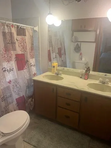 a bathroom with a toilet and a shower