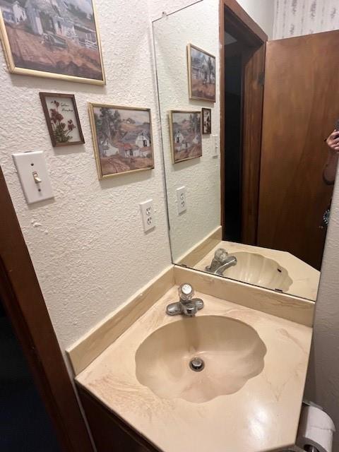 915 Highway 84 Mullin, TX 76864 - Photo 16 of 37 a bathroom with a sink and a mirror
