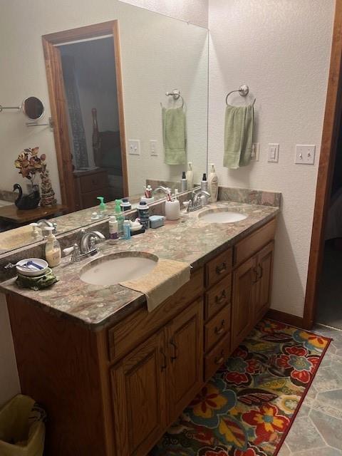 915 Highway 84 Mullin, TX 76864 - Photo 20 of 37 a bathroom with a granite countertop sink and a mirror