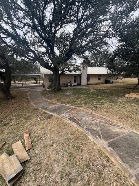 915 Highway 84 Mullin, TX 76864 - Photo 6 of 37 a house with trees in front of it