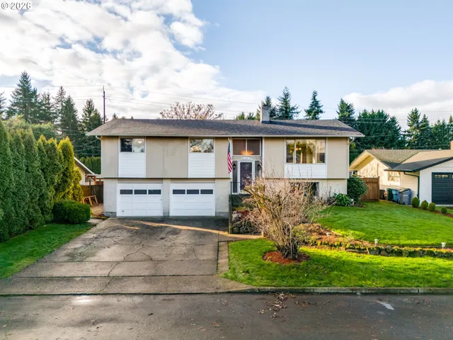 a view of a house with a yard and fence