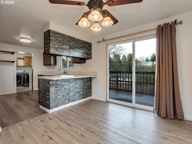 a view of a kitchen with a sink and a large window