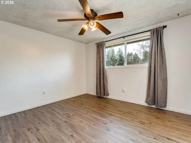 a bedroom with a large bed and a potted plant