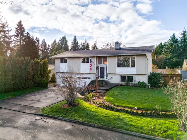 a view of a house with backyard sitting area and garden