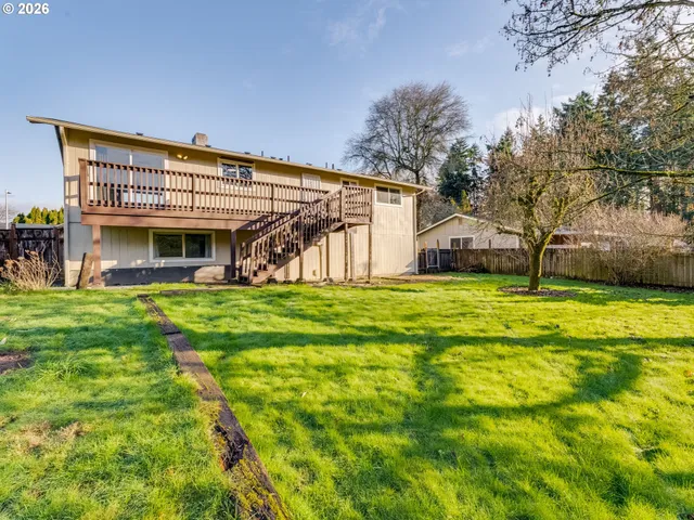 a view of a backyard with swimming pool