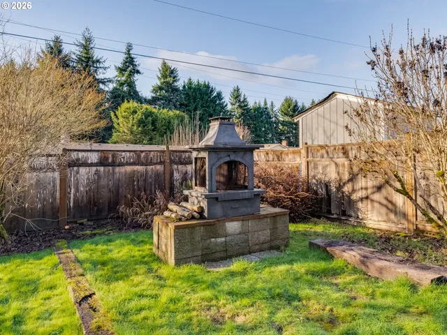 an aerial view of a house with a yard and pool