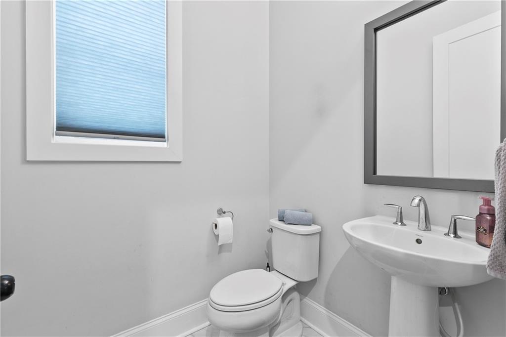 120 Meadow Mill Road Woodstock, GA 30188 - Photo 11 of 56 a bathroom with a toilet a sink and mirror