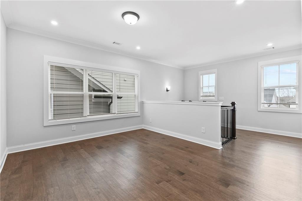 120 Meadow Mill Road Woodstock, GA 30188 - Photo 16 of 56 an empty room with wooden floor and windows