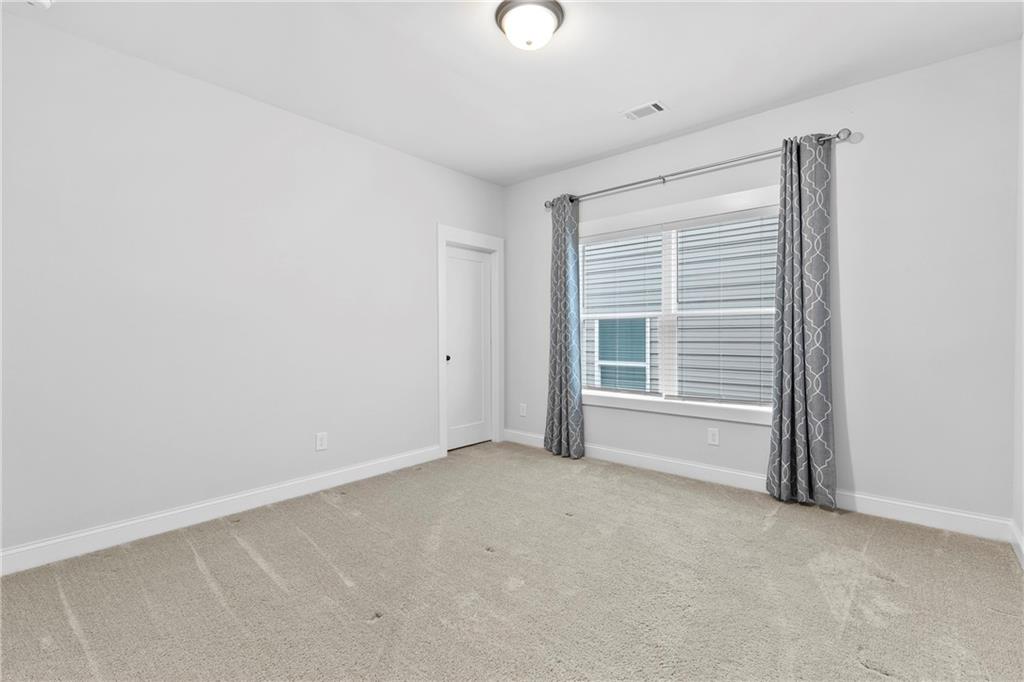 120 Meadow Mill Road Woodstock, GA 30188 - Photo 17 of 56 a view of an empty room with a window