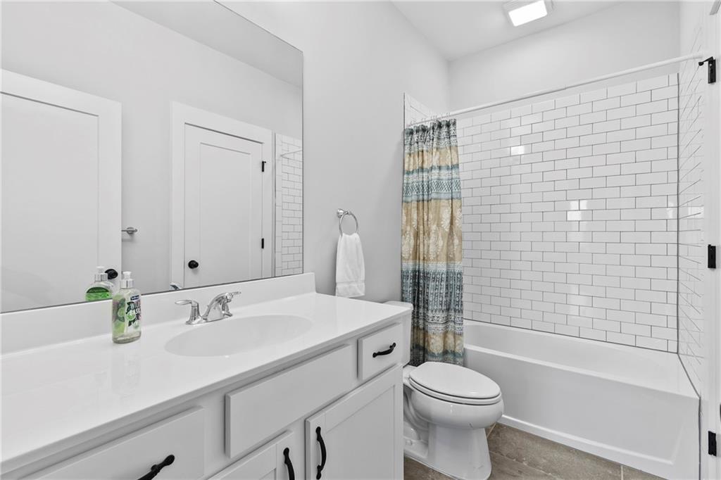 120 Meadow Mill Road Woodstock, GA 30188 - Photo 18 of 56 a bathroom with a sink toilet and shower