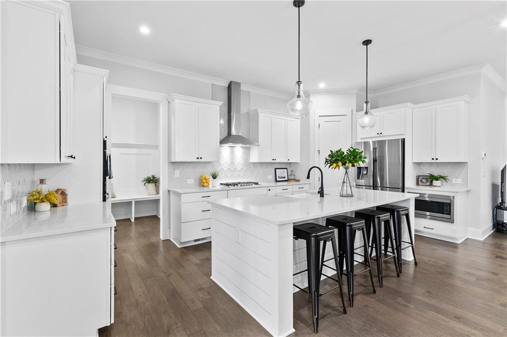 120 Meadow Mill Road Woodstock, GA 30188 - Photo 2 of 56 a kitchen with white cabinets and refrigerator