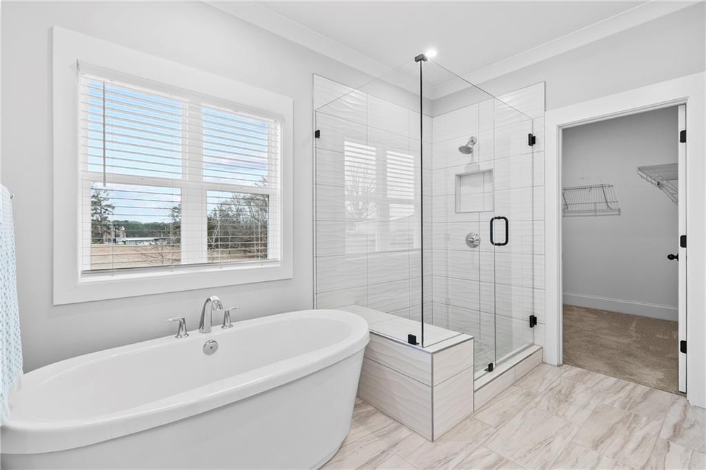 120 Meadow Mill Road Woodstock, GA 30188 - Photo 21 of 56 a bathroom with a tub shower and window