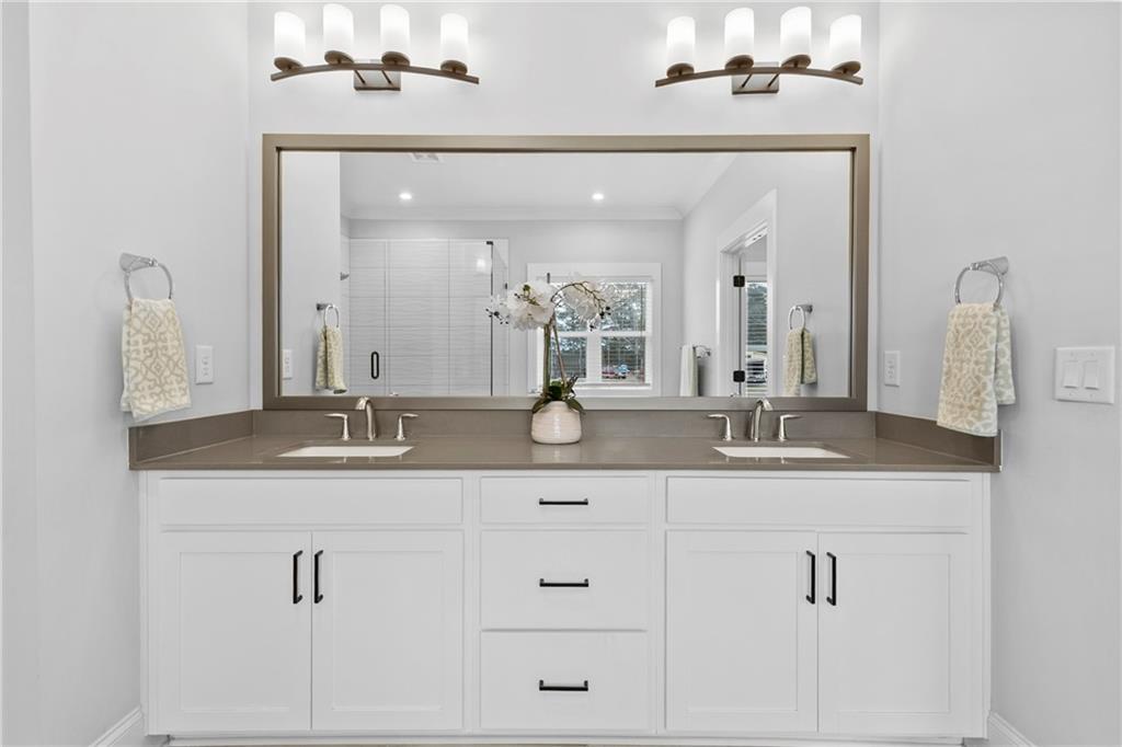 120 Meadow Mill Road Woodstock, GA 30188 - Photo 22 of 56 a bathroom with double sink and a mirror