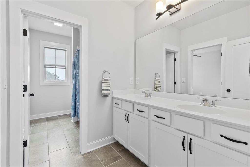 120 Meadow Mill Road Woodstock, GA 30188 - Photo 23 of 56 a spacious bathroom with a double vanity sink mirror and