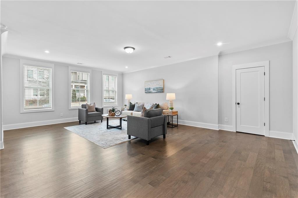 120 Meadow Mill Road Woodstock, GA 30188 - Photo 26 of 56 a living room with furniture and a wooden floor