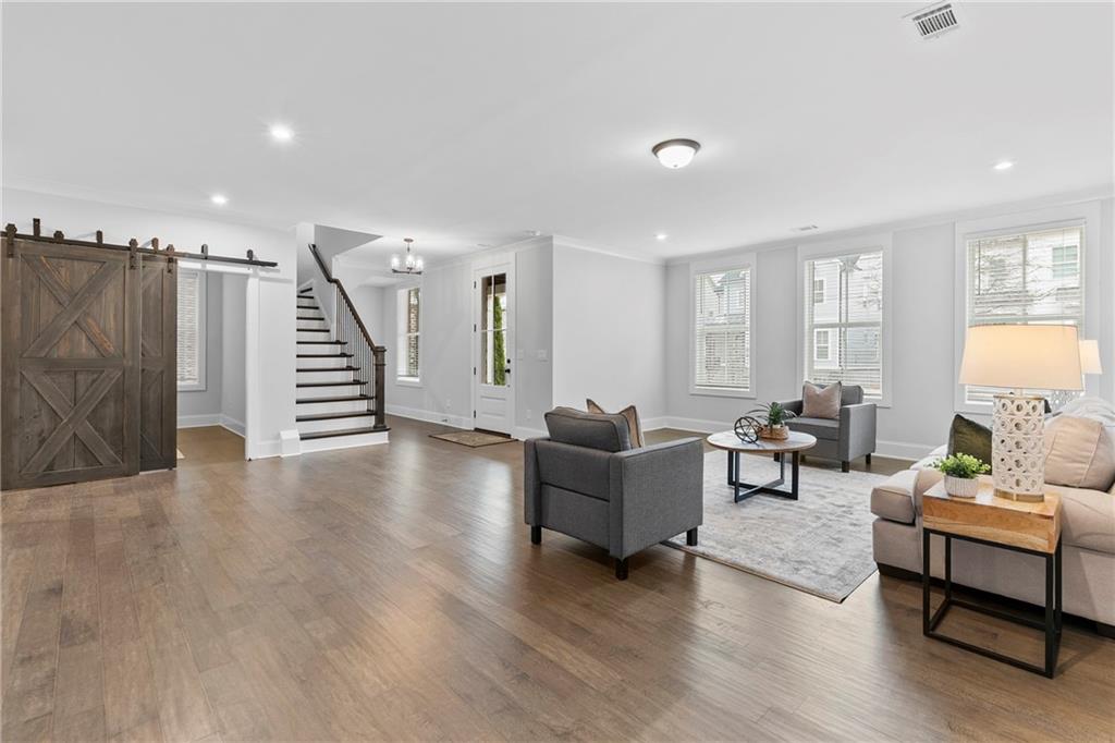 120 Meadow Mill Road Woodstock, GA 30188 - Photo 27 of 56 a living room with furniture and wooden floor