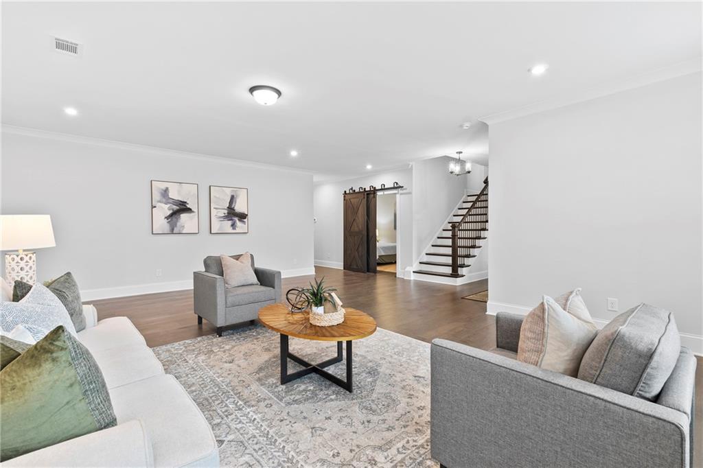 120 Meadow Mill Road Woodstock, GA 30188 - Photo 28 of 56 a living room with furniture and wooden floor