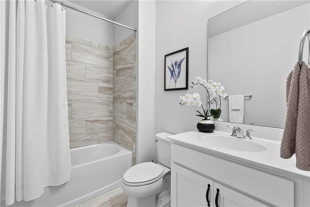 120 Meadow Mill Road Woodstock, GA 30188 - Photo 30 of 56 a bathroom with a sink toilet and shower