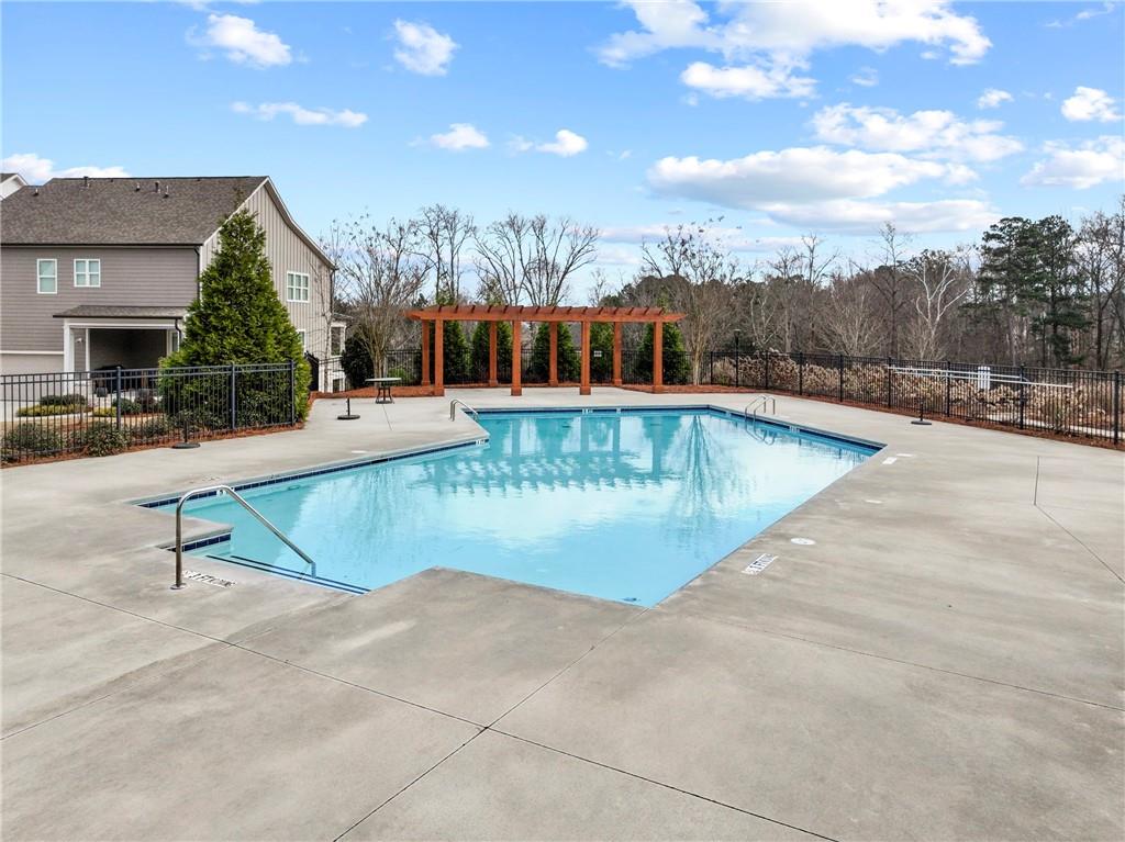 120 Meadow Mill Road Woodstock, GA 30188 - Photo 40 of 56 a view of a swimming pool with a lounge chairs