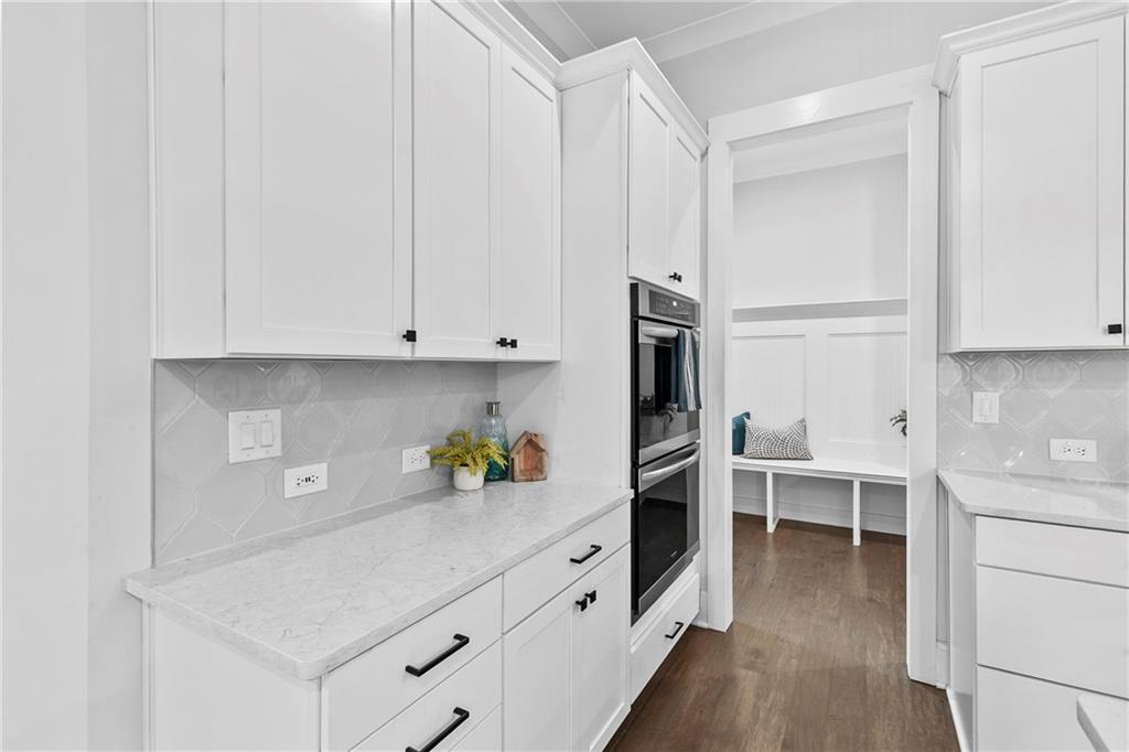 120 Meadow Mill Road Woodstock, GA 30188 - Photo 4 of 56 a kitchen with white cabinets and refrigerator