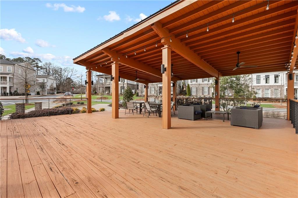 120 Meadow Mill Road Woodstock, GA 30188 - Photo 42 of 56 a view of a patio with table and chairs under an umbrella