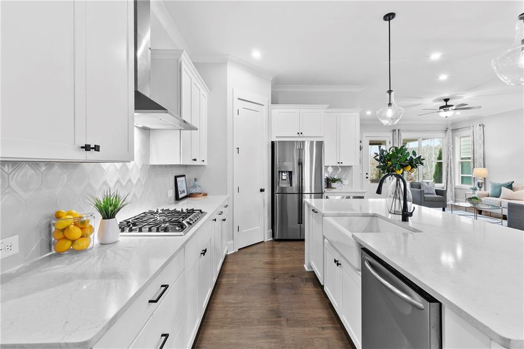 120 Meadow Mill Road Woodstock, GA 30188 - Photo 5 of 56 a kitchen with stainless steel appliances kitchen island granite countertop a sink a counter space and cabinets