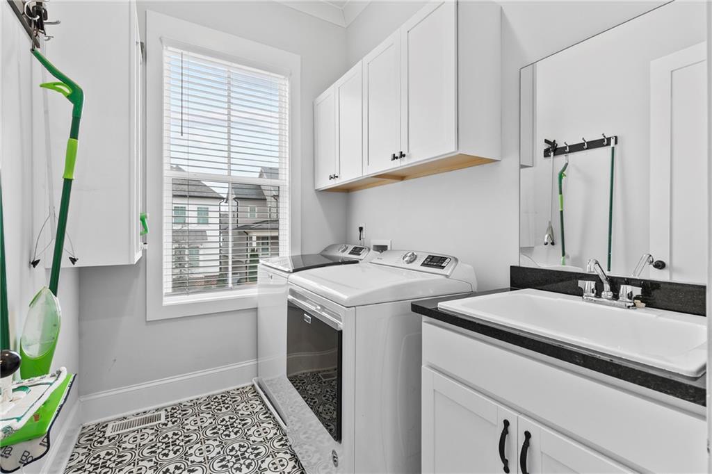 120 Meadow Mill Road Woodstock, GA 30188 - Photo 10 of 56 a utility room with stainless steel appliances a stove a sink and a window