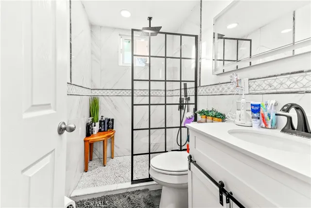 a bathroom with a sink toilet and shower