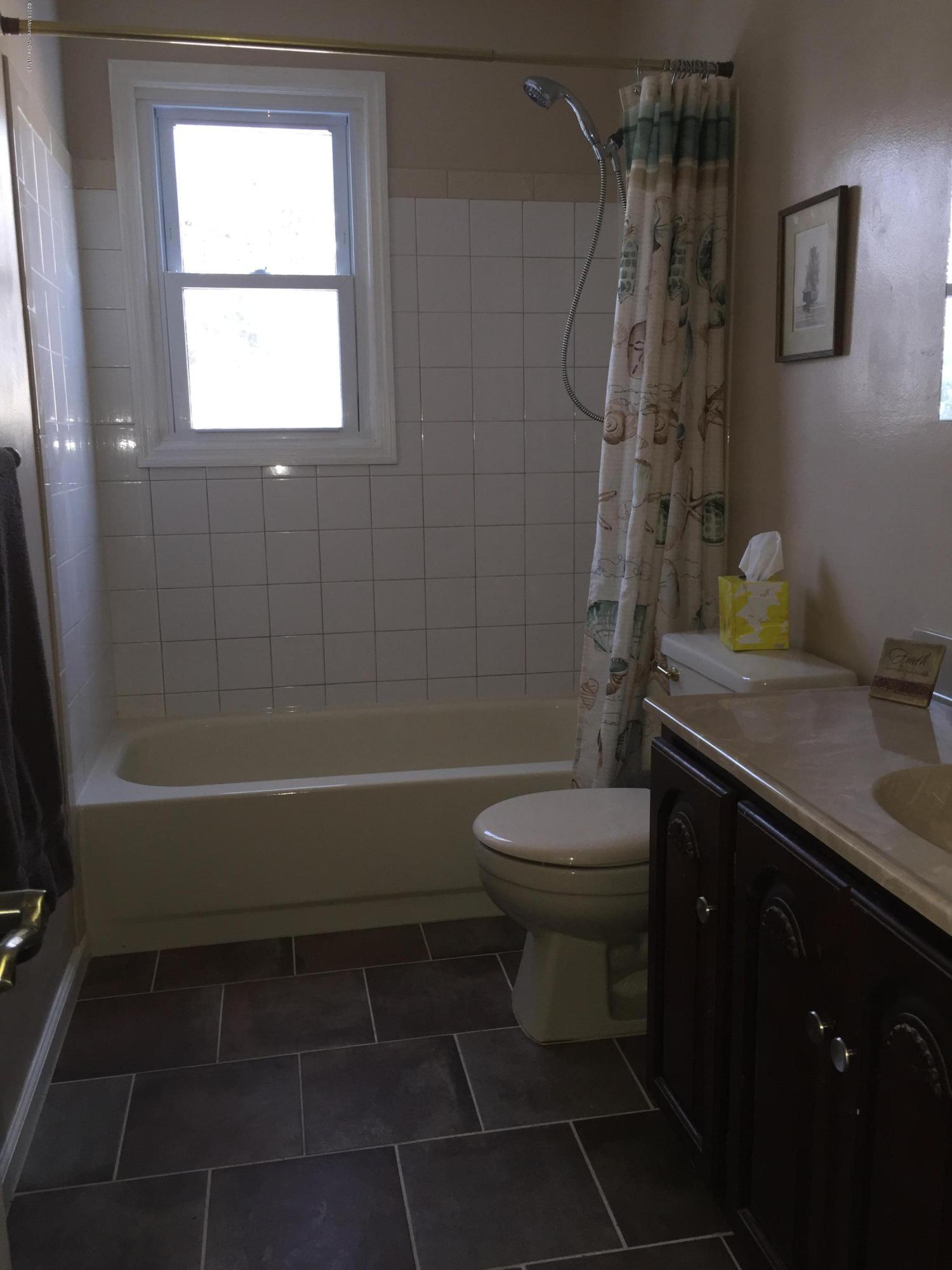 417 Couse Road Neptune Township, NJ 07753 - Photo 19 of 26 a bathroom with a sink a toilet and shower