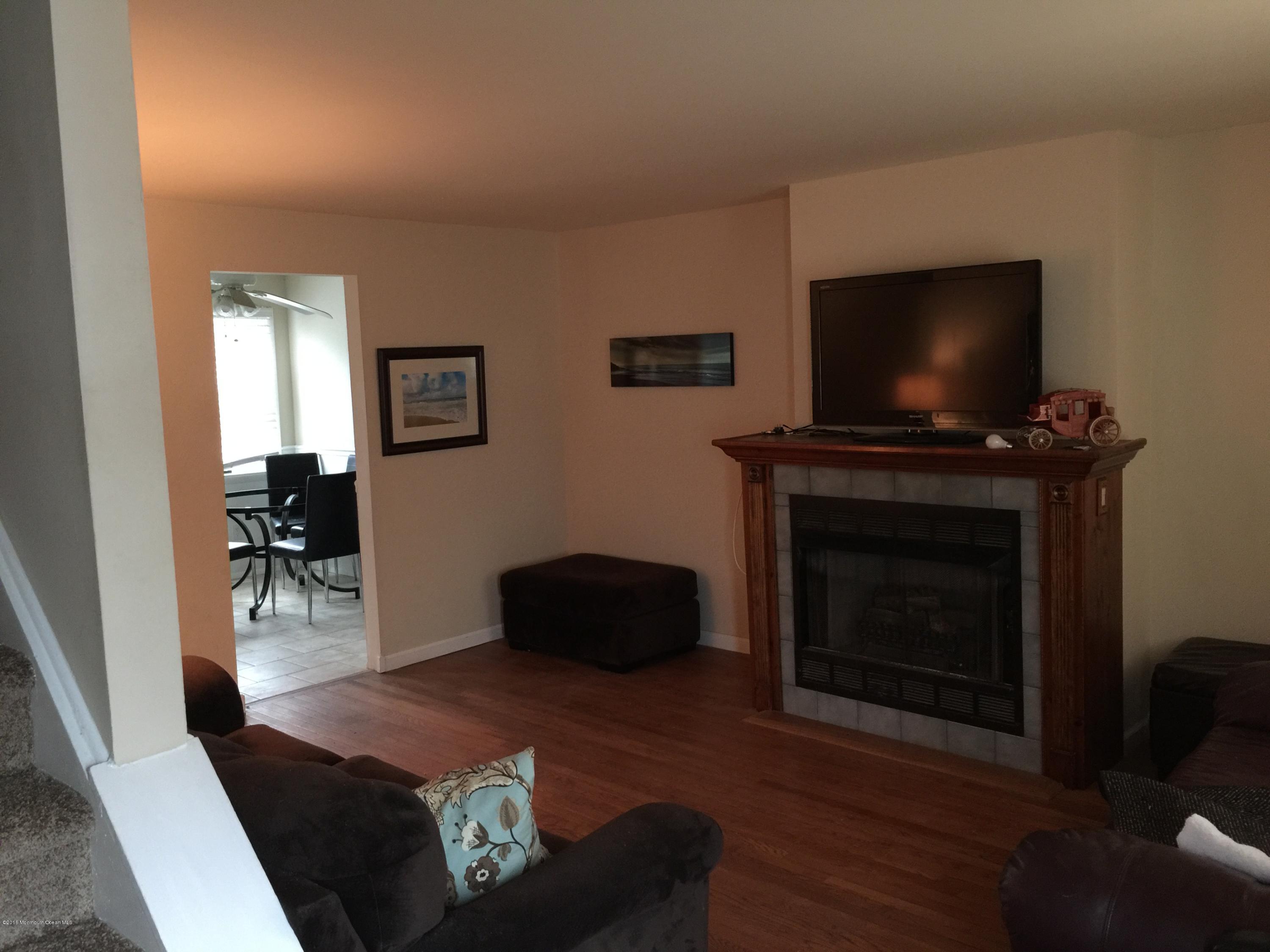 417 Couse Road Neptune Township, NJ 07753 - Photo 4 of 26 a living room with furniture and a fireplace