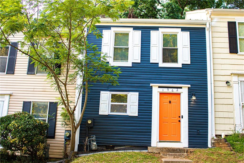 1962 Village Parkway Smyrna, GA 30080 - Photo 1 of 55 a view of a house with a door and a tree