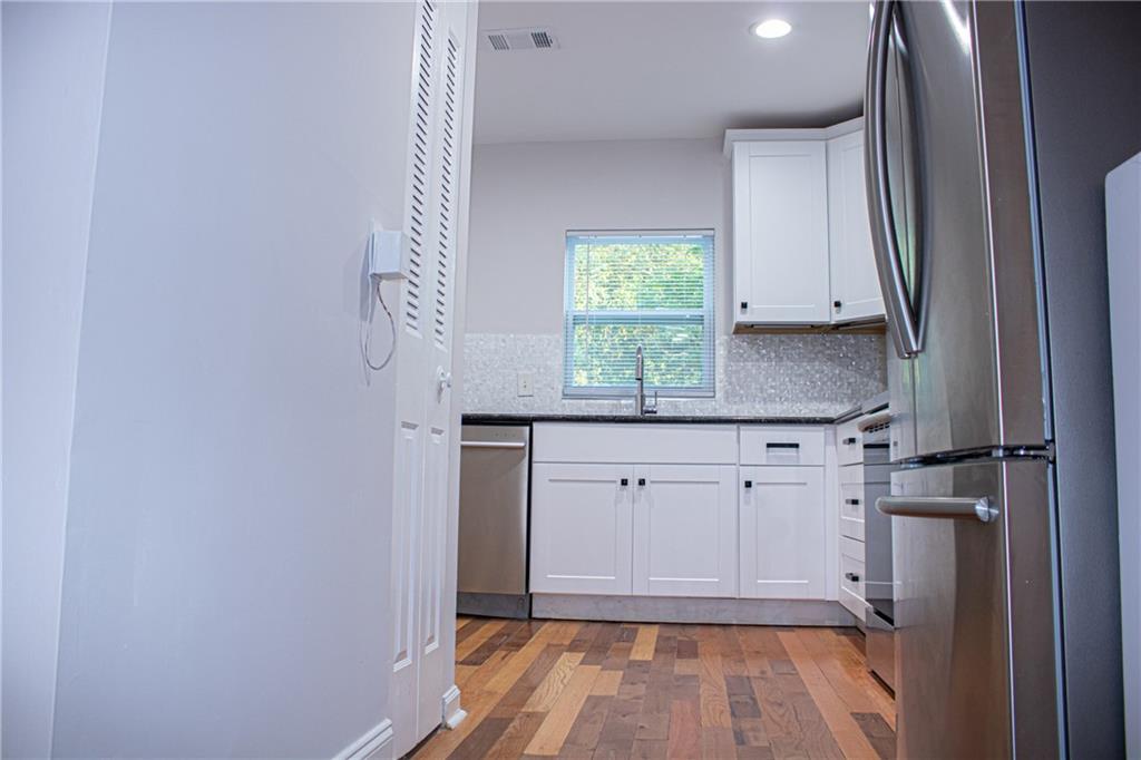 1962 Village Parkway Smyrna, GA 30080 - Photo 12 of 55 a kitchen with white cabinets and a window