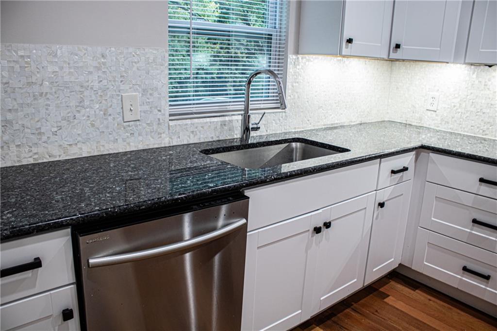 1962 Village Parkway Smyrna, GA 30080 - Photo 16 of 55 a kitchen with granite countertop a sink and a window