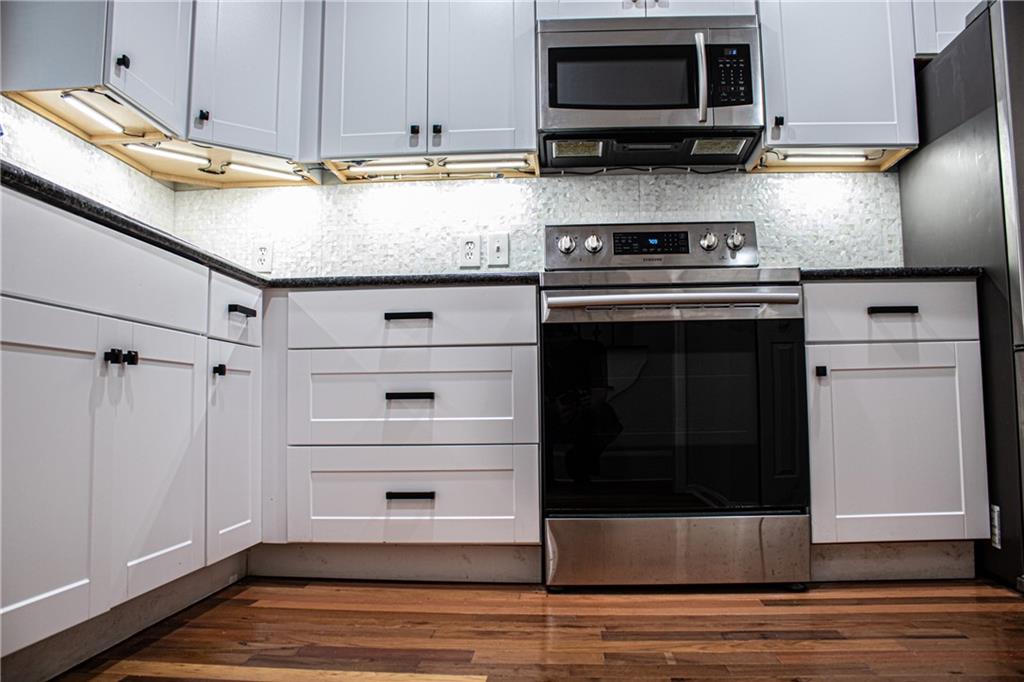 1962 Village Parkway Smyrna, GA 30080 - Photo 20 of 55 a kitchen with stainless steel appliances granite countertop a stove microwave and refrigerator