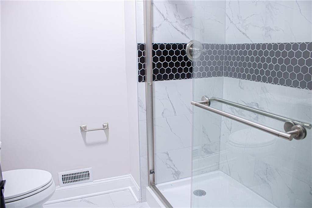 1962 Village Parkway Smyrna, GA 30080 - Photo 32 of 55 a bathroom with a bathtub and a shower