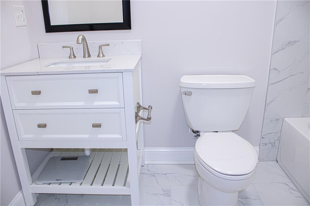 1962 Village Parkway Smyrna, GA 30080 - Photo 37 of 55 a bathroom with a toilet sink and mirror