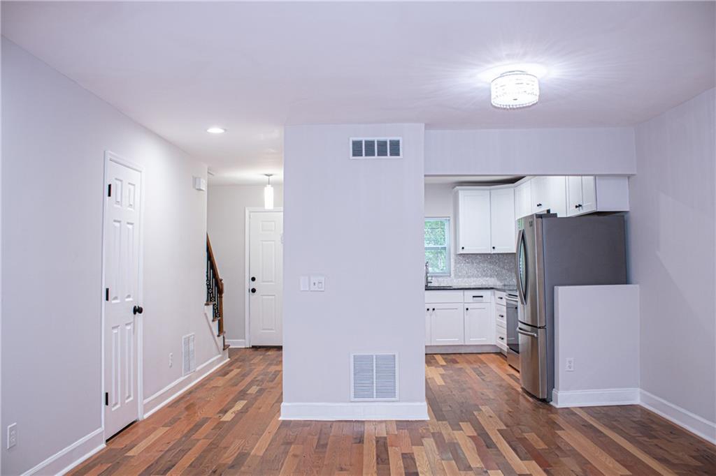 1962 Village Parkway Smyrna, GA 30080 - Photo 6 of 55 a kitchen with stainless steel appliances a refrigerator and a wooden floor