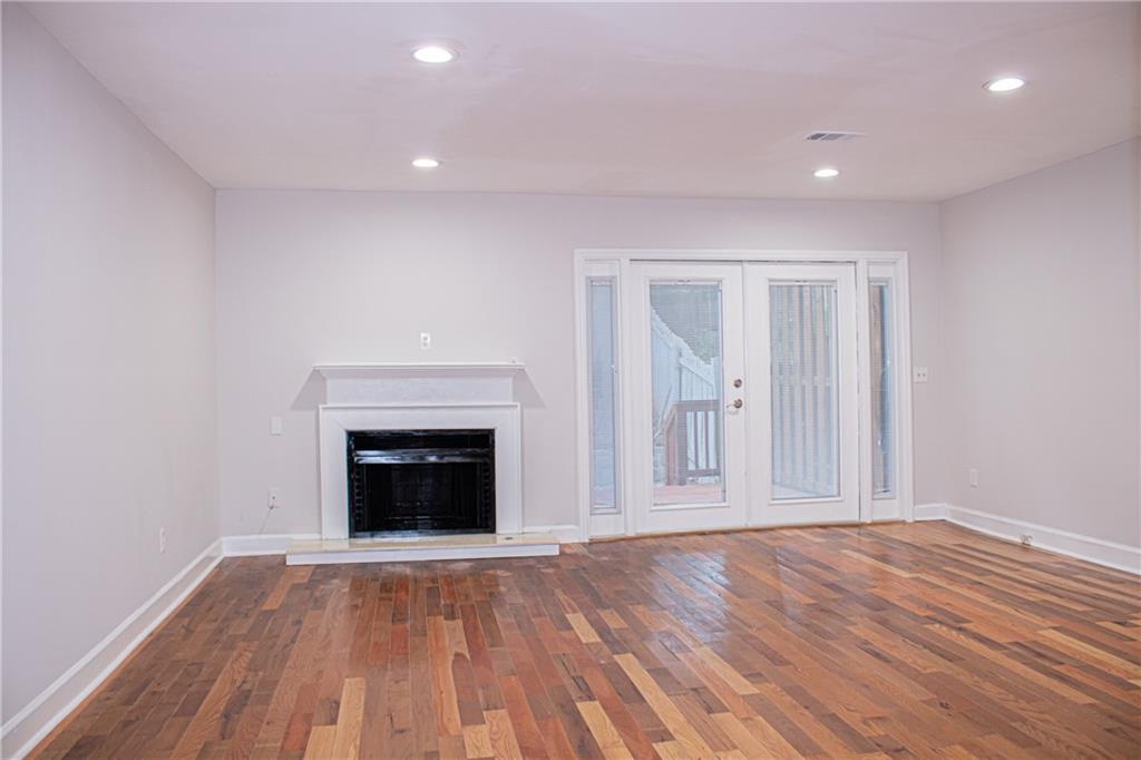 1962 Village Parkway Smyrna, GA 30080 - Photo 8 of 55 a view of an empty room with wooden floor fireplace and a window