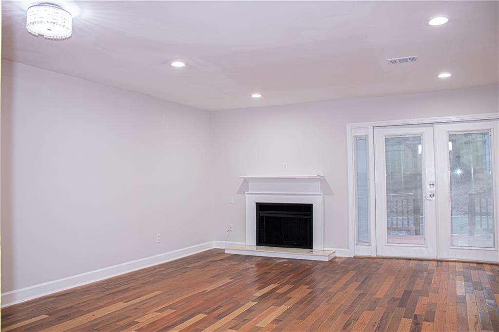 1962 Village Parkway Smyrna, GA 30080 - Photo 9 of 55 a view of empty room with wooden floor and fireplace